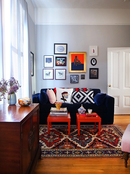 Blue velvet couch in a warm living room