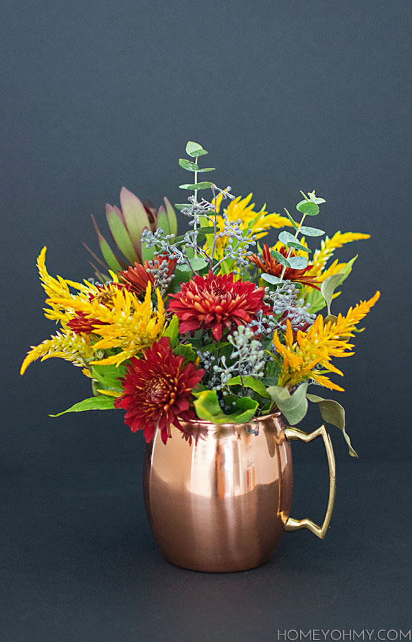 Fall flowers in a copper mug