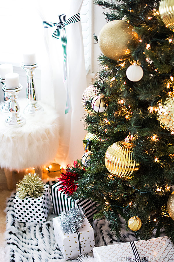 Christmas tree with gold ornaments.  Use a fur throw as a simple tree skirt!