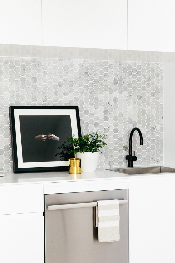 black faucet hex tile