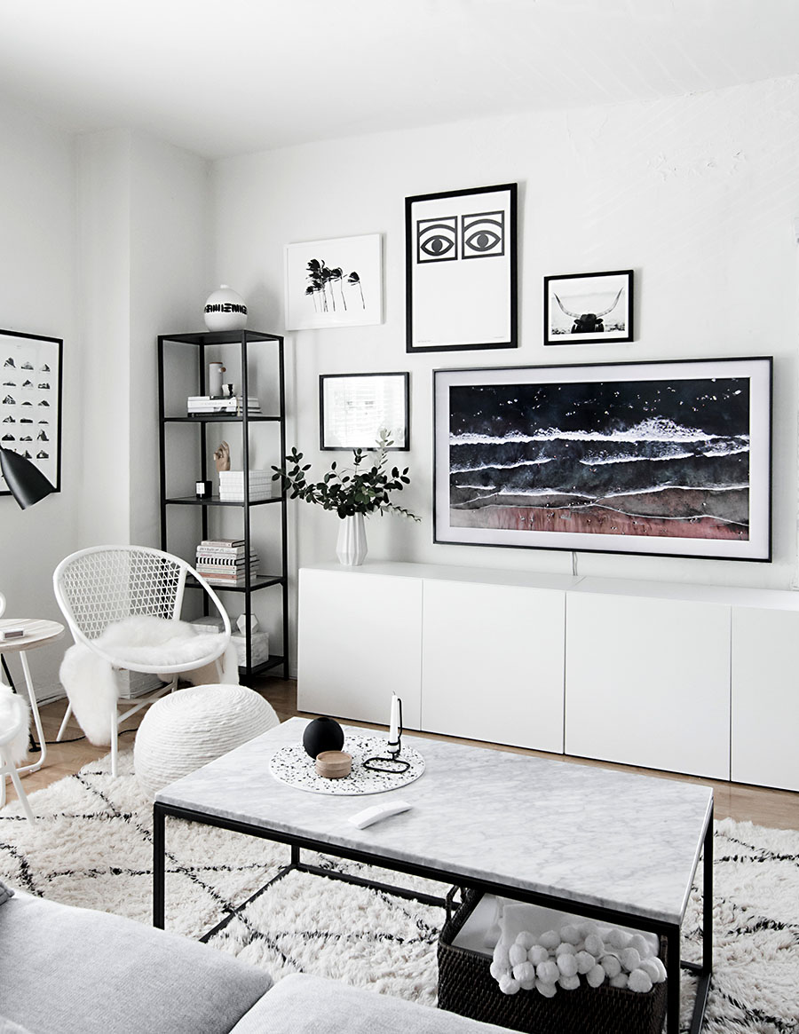 black and white minimalist living room with hidden TV artwork